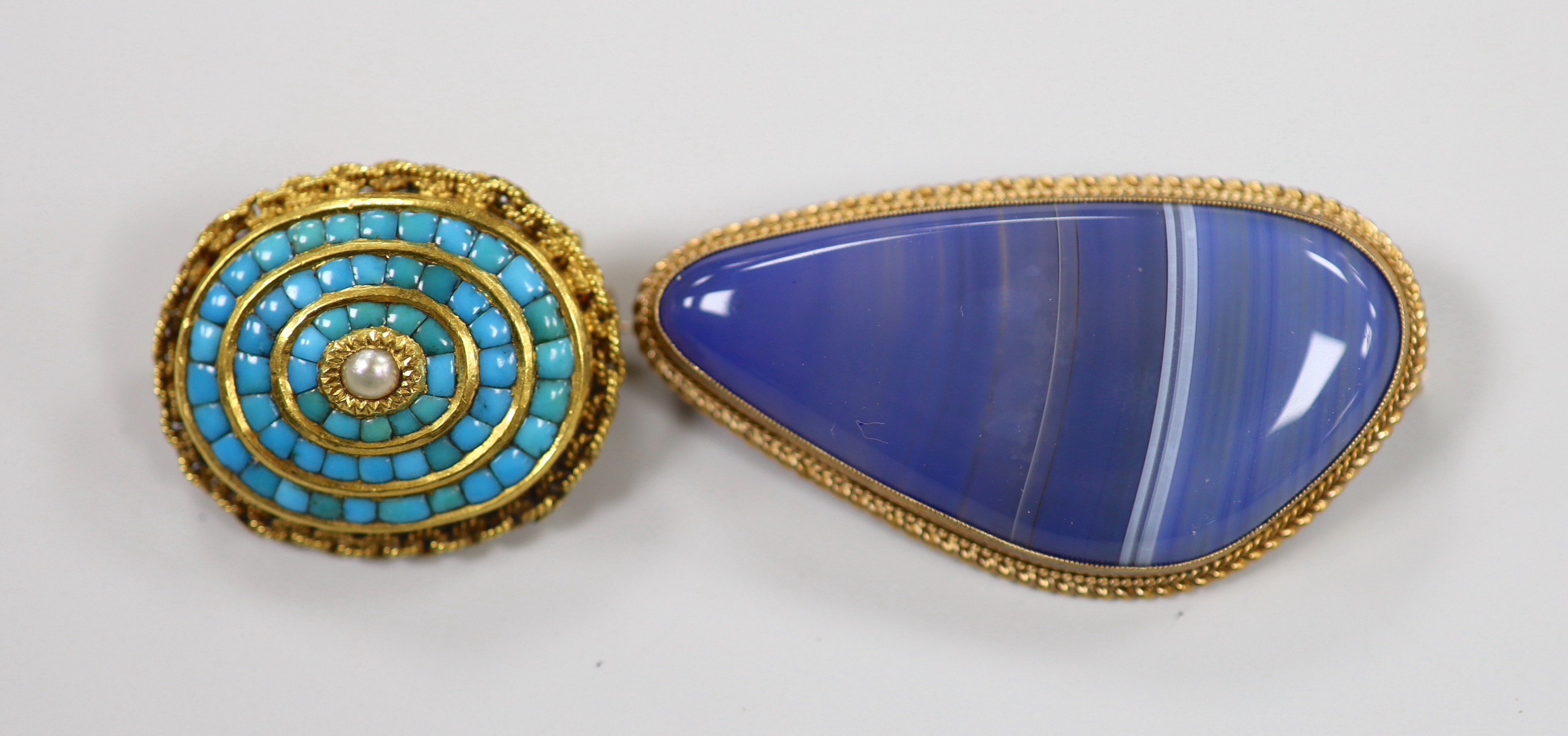 A modern 9ct gold mounted blue banded agate brooch, 47mm and an earlier yellow metal and turquoise cluster brooch, gross weight 25.3 grams.
